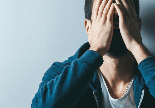 Man with hands over face